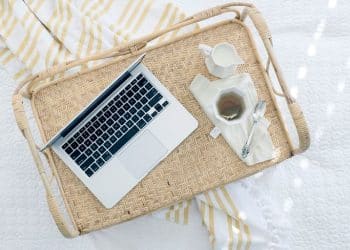 gray laptop computer on beige wicker chair