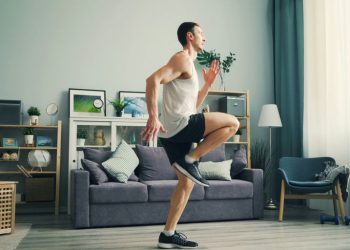 a man is dancing in a living room
