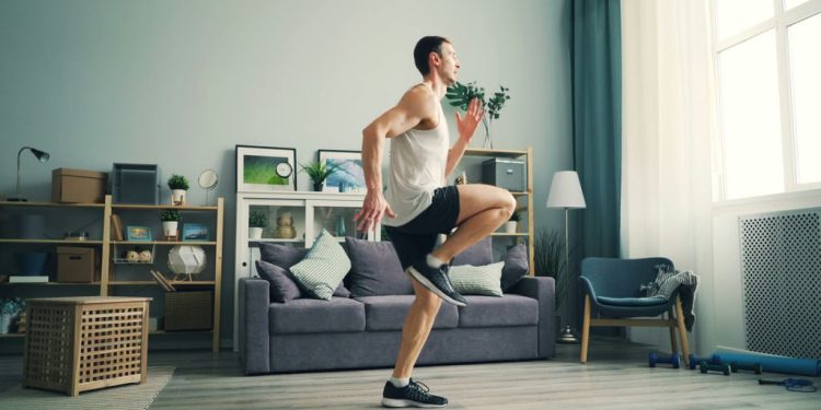a man is dancing in a living room