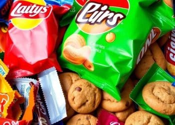 Variety of individually wrapped snacks on a table.